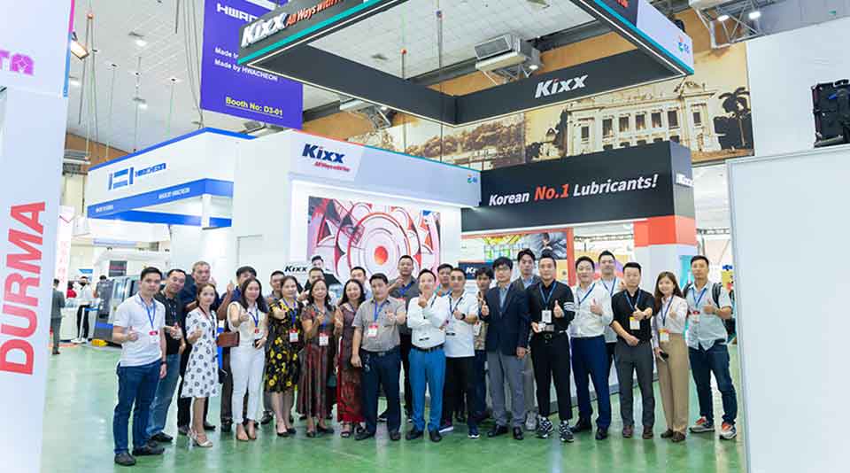 Kixx staff and visitors posing in front of the Kixx booth at MTA Hanoi 2022